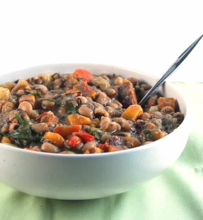 Black Eyed Peas Stew in white bowl with bell peppers