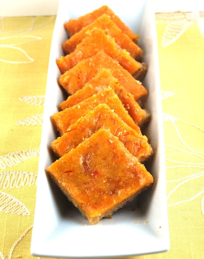 Saffron Cheesecake Bars in a rectangular bowl.