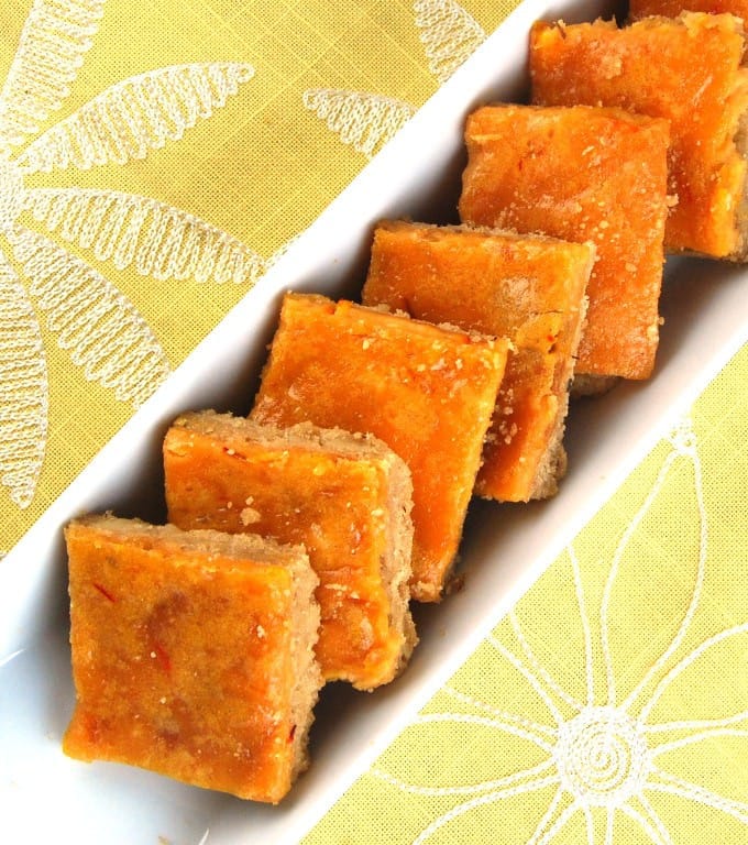 Saffron Cheesecake Bars in  a rectangular bowl.