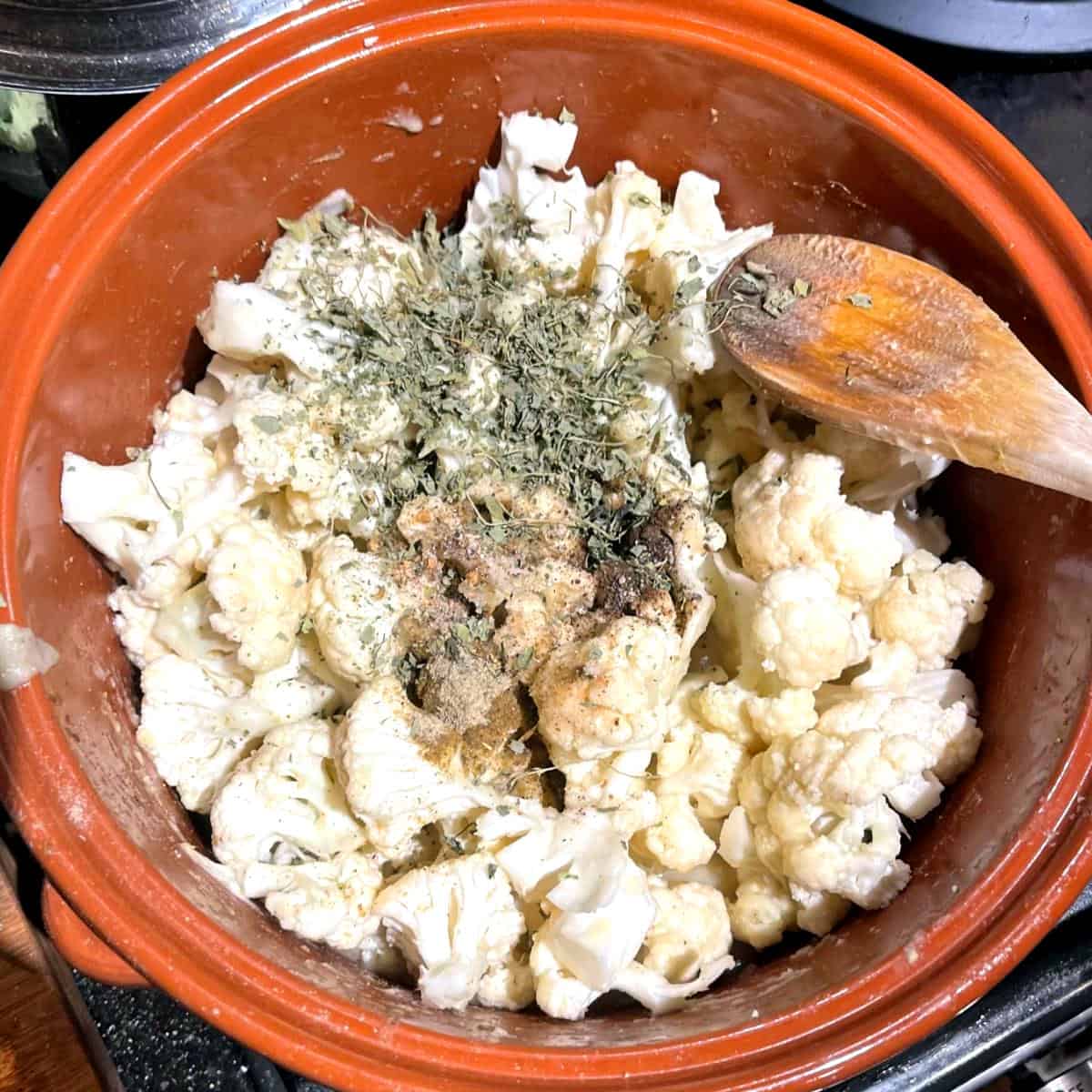 Kasoori methi, cardamom, salt, and pepper added to pot with cauliflower.