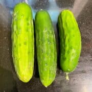 Three cucumbers arranged side by side.