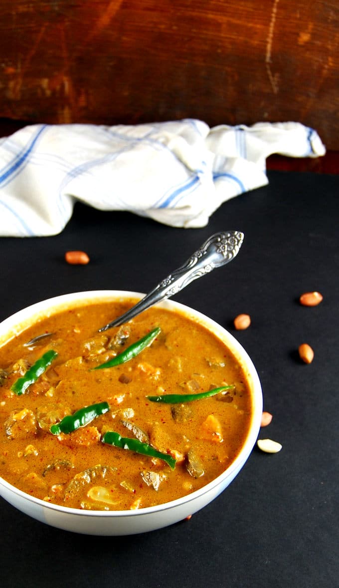 A bowl of vegan African Peanut Stew with a garnish of chilies - holycowvegan.net