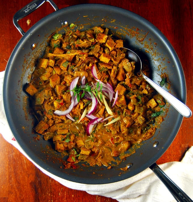 A large nonstick pan with Kadai Tofu, red onions and mint.