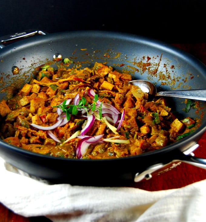 A large nonstick pan with Kadai Tofu, red onions and mint.
