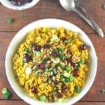 Pumpkin Biryani topped with candied cranberries and pumpkin seeds. A vegan and gluten-free recipe.