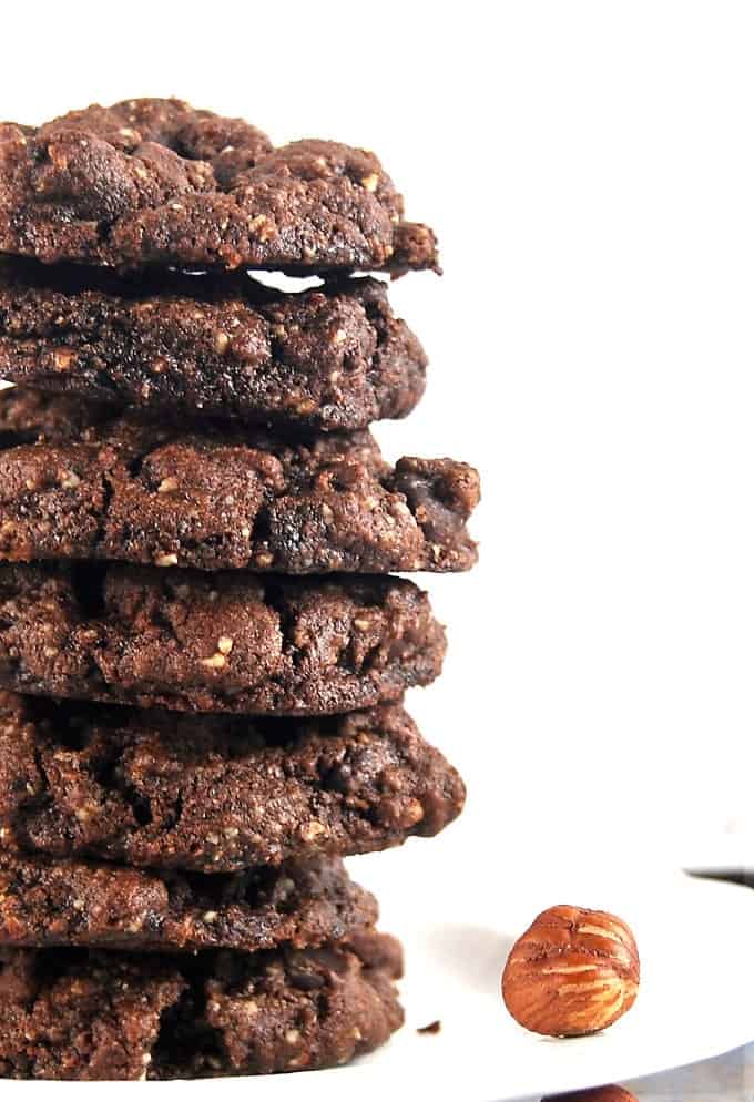 Closeup of a stack of double chocolate hazelnut cookies on a white plate