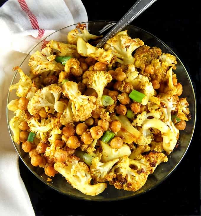 A glass bowl with Roasted Cauliflower and Chickpeas