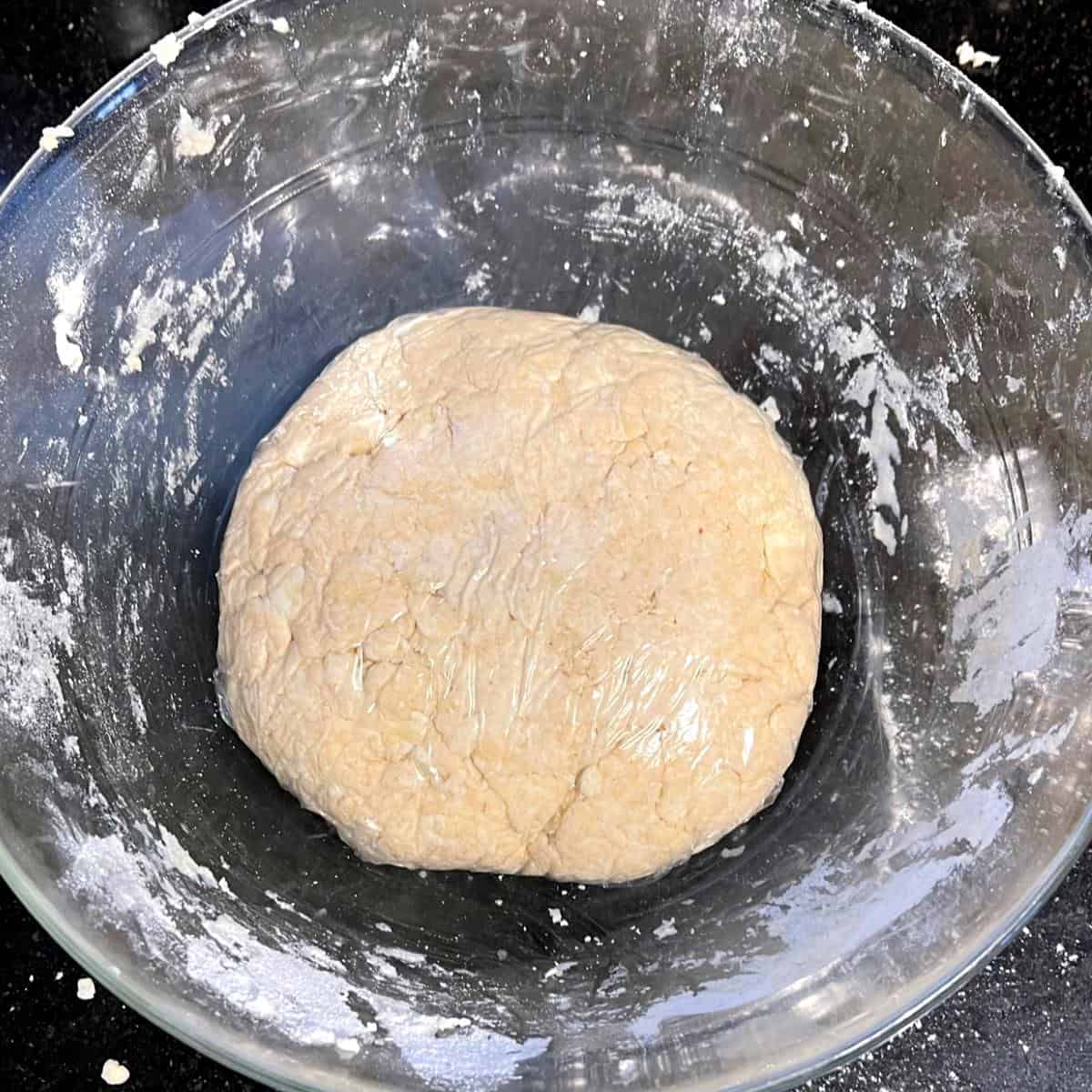 Vegan irish hand pie dough wrapped in cling wrap.