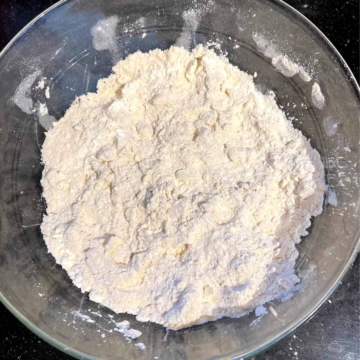 Butter cut into flour for Irish vegan hand pies.