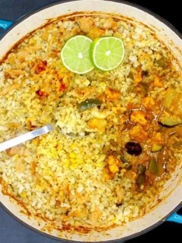 A bowl of food on a plate, with Biryani