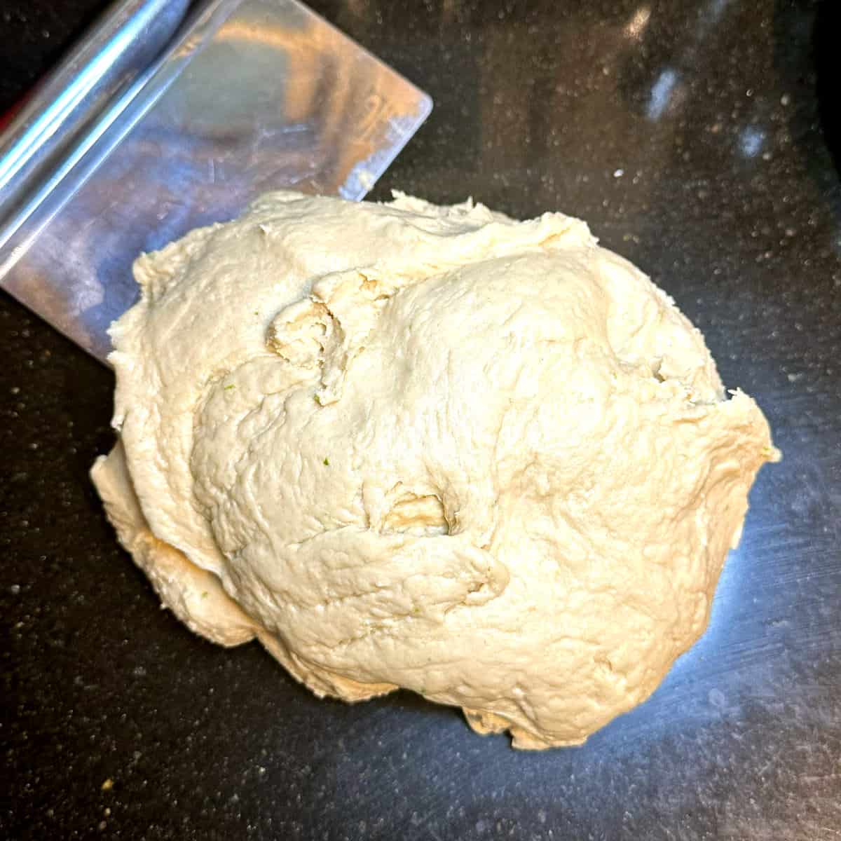 Vegan babka dough, kneaded, with bench scraper.