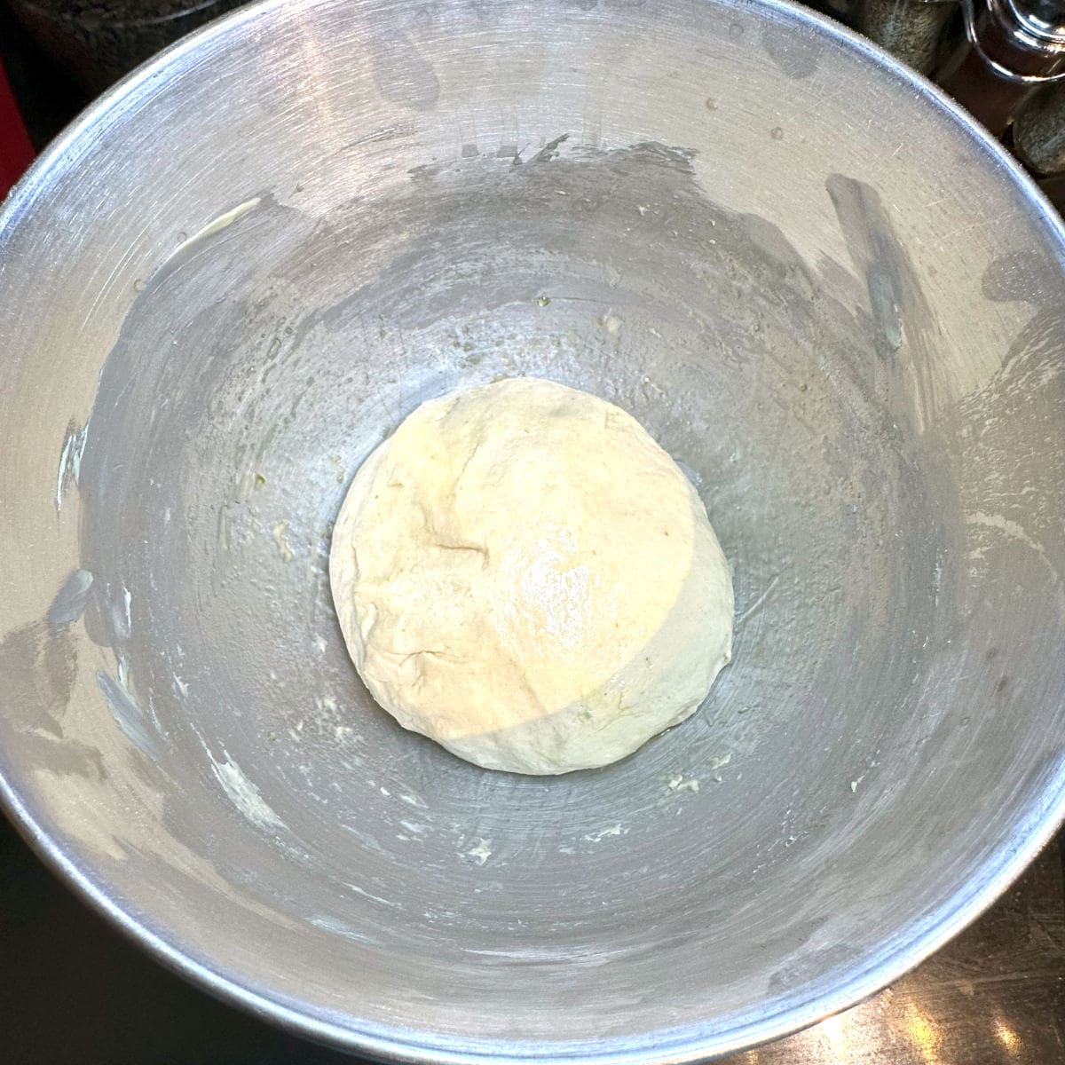 Vegan chocolate babka dough after kneading, formed into a ball, in stand mixer bowl.