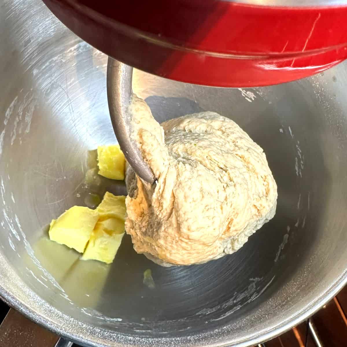 Butter added to stand mixer bowl with vegan chocolate babka dough.