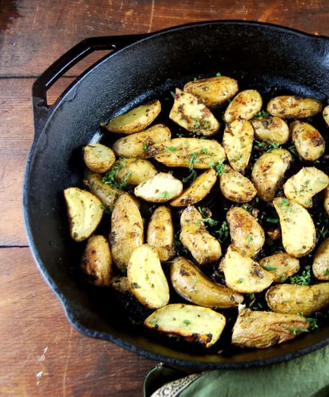 Herb Garlic Roasted Fingerling Potatoes in a cast iron pan.