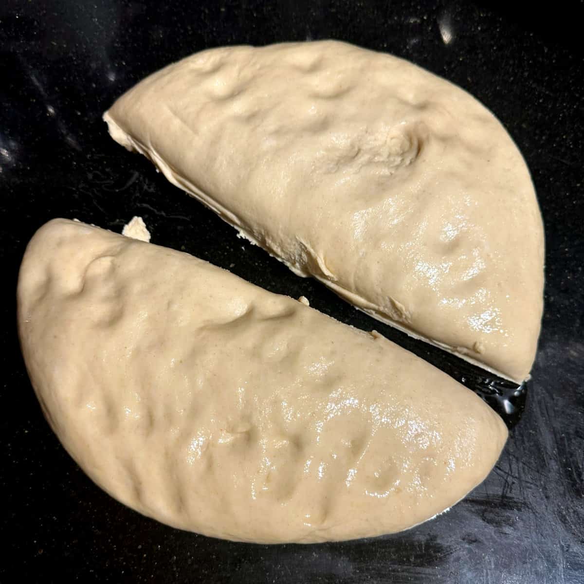 Dough punched down and divided in half.