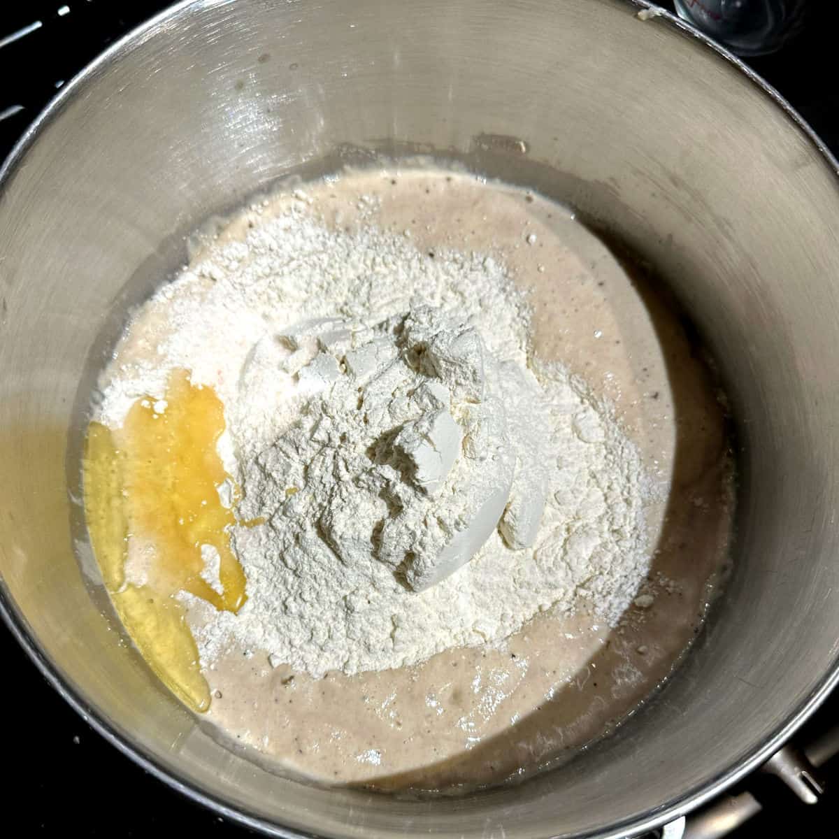 Flour, salt and oil added to bowl with flour in stand mixer.