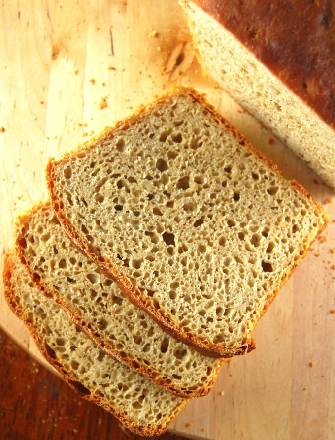 Slices of All Whole Wheat Sourdough Sandwich Bread on chopping board.