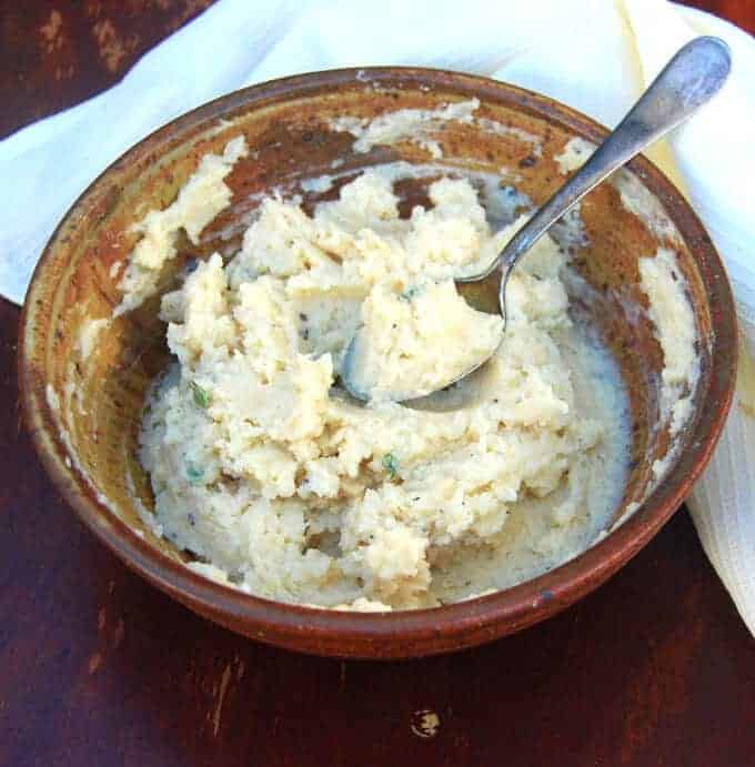 Mashed lima bean "potatoes" with vegan onion gravy in a bowl.