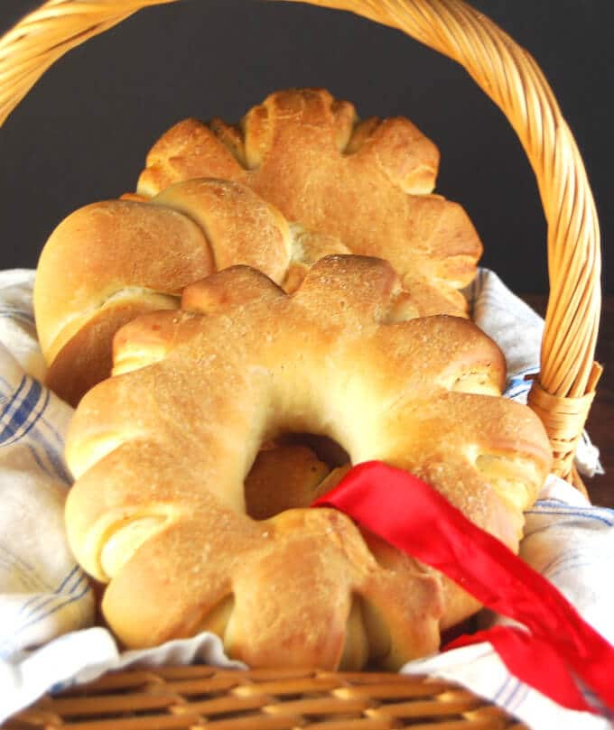 Closeup of a Christmas Wreath Rolls in basket with red ribbon.