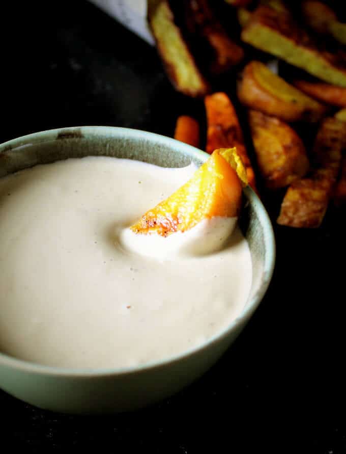 Magic Cheesy Sauce in bowl with roasted root veggies.