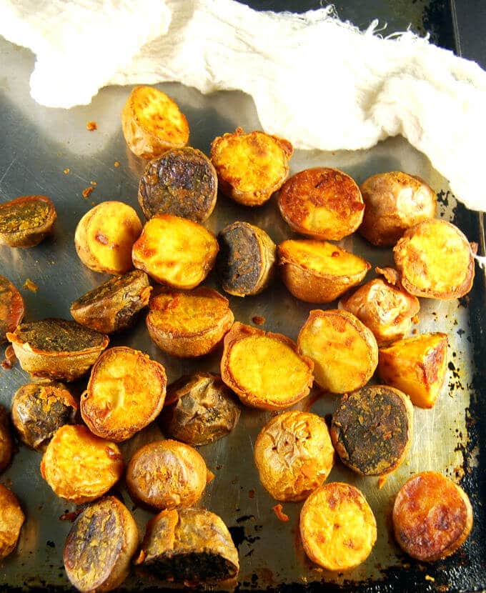 Crunchy Chickpea Roasted Potatoes on a baking sheet with cheesecloth.