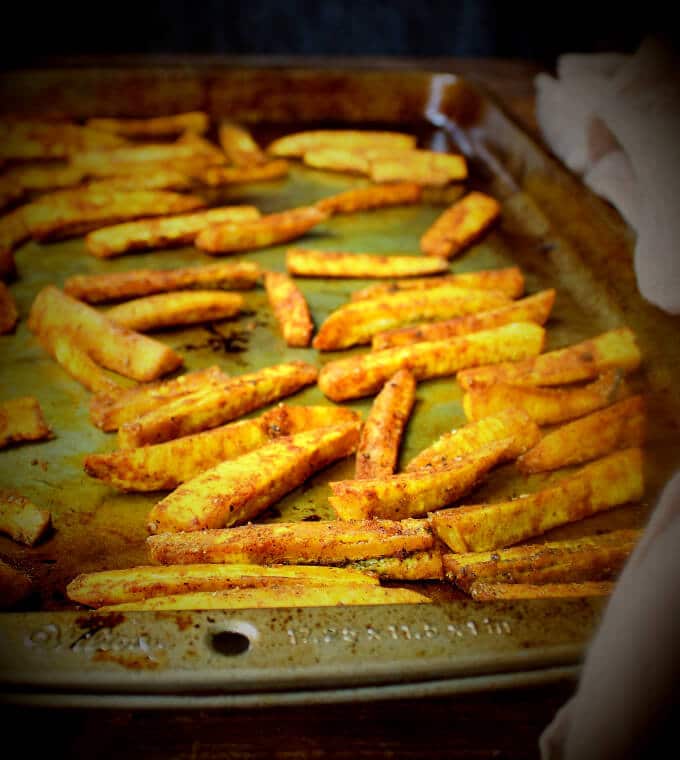 Plantain fries on baking sheet.