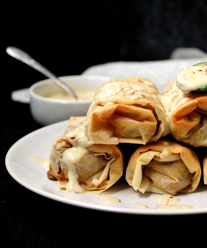 Photo of a stack of Vegan baked chimichangas with filo and lentil stuffing