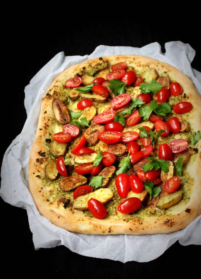 The perfect vegan pizza with a crispy, golden crust and a summery topping of fingerling potatoes, cherry tomatoes and a delicate parsley pesto.
