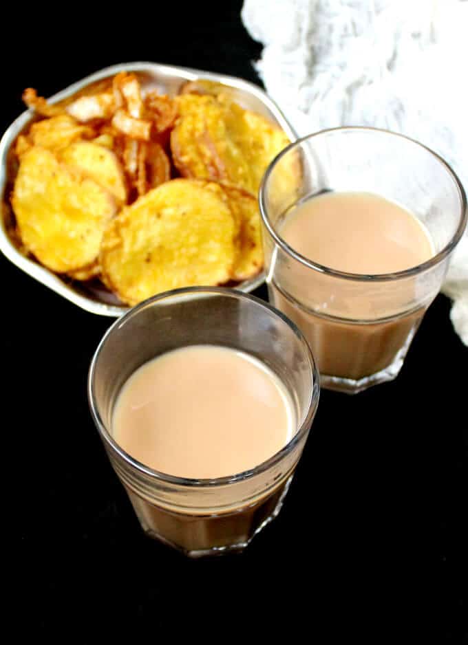 Vegan Cutting Chai in glasses with pakoras on the side.