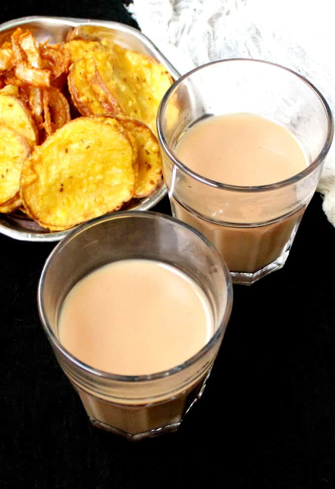 Vegan Cutting Chai in glasses with a plate of pakoras.