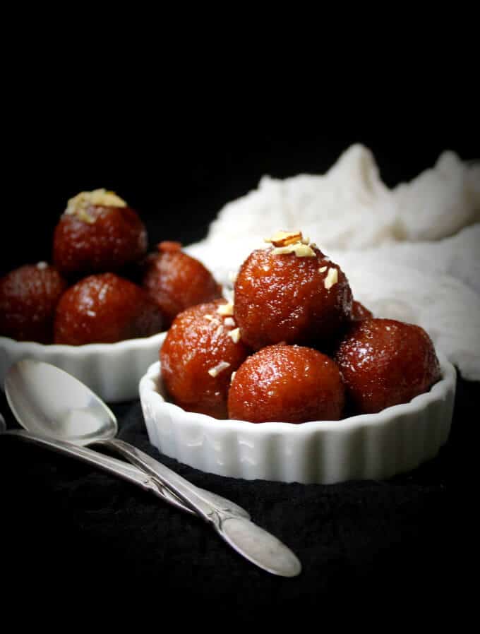Vegan Gulab Jamun front shot in white bowls and with spoons.