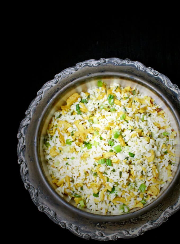 Overhead shot of a serving dish with vegan Indo Chinese "Egg" Fried Rice. Vegan, soy-free, gluten-free and nut-free. | holycowvegan.net