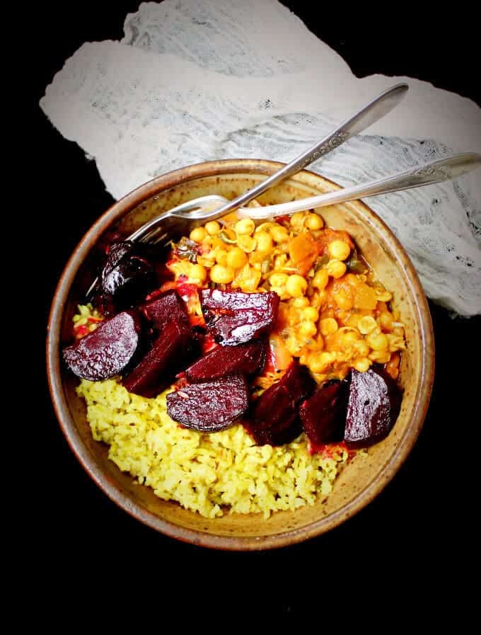 Vegan Curry Sprouts Bowl with Pickled Beets and Minty Brown Rice in bowl with forks.