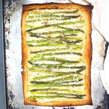 Vegan asparagus pizza on baking sheet.
