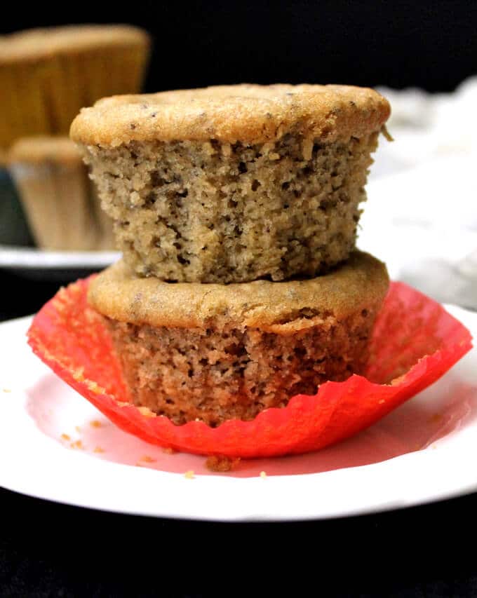 Vegan Almond Flour Chia Seed Muffins stacked on white plate with red liner.
