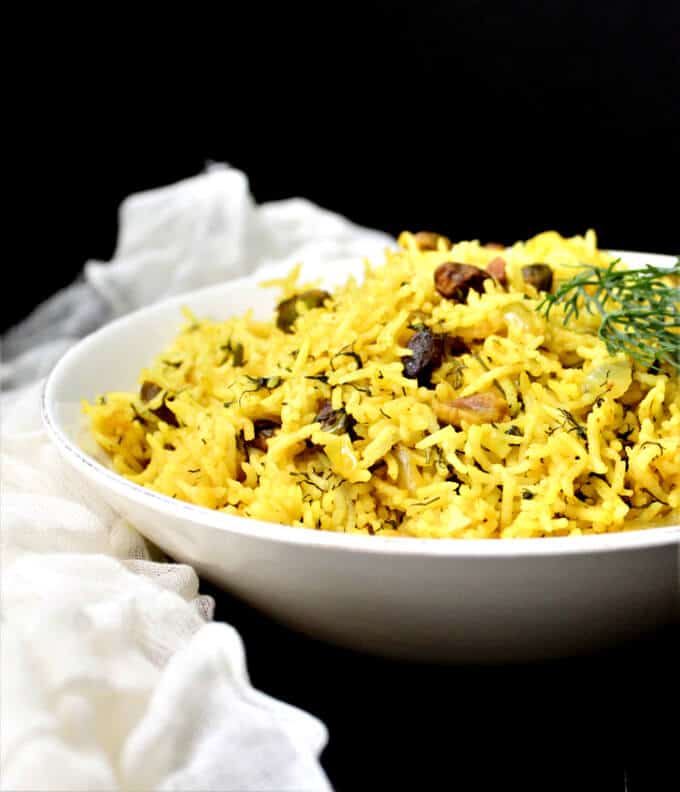 Dill Turmeric Pilaf with Pistachios in white bowl.