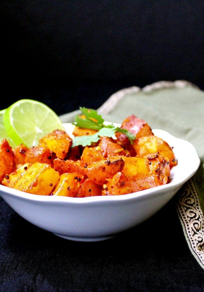 Masala Potatoes in bowl with lemon slices.