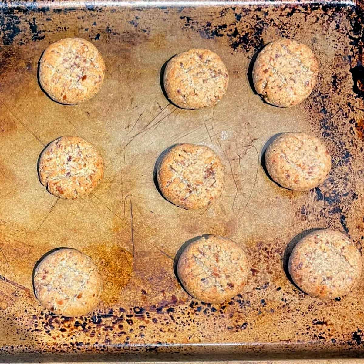 Baked almond flour cookies on baking sheet.
