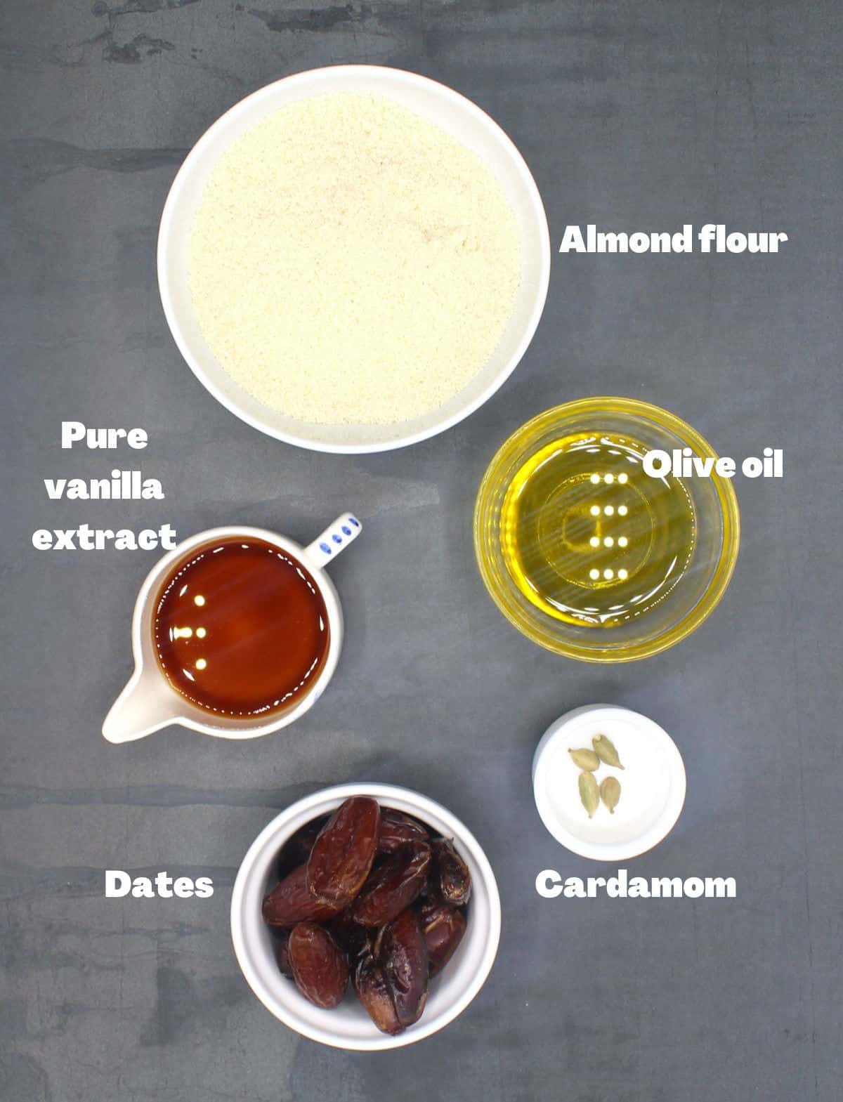 Ingredients for vegan almond flour cookies, including almond flour, vanilla, oil, dates and cardamom.