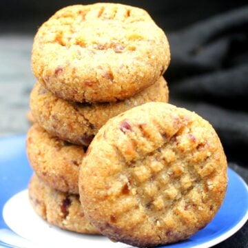 Vegan almond flour cookies stacked in plate.