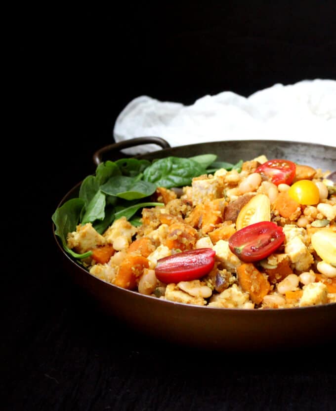 Curried Tempeh Quinoa Breakfast Hash with Sweet Potatoes and White Beans in a copper pan.