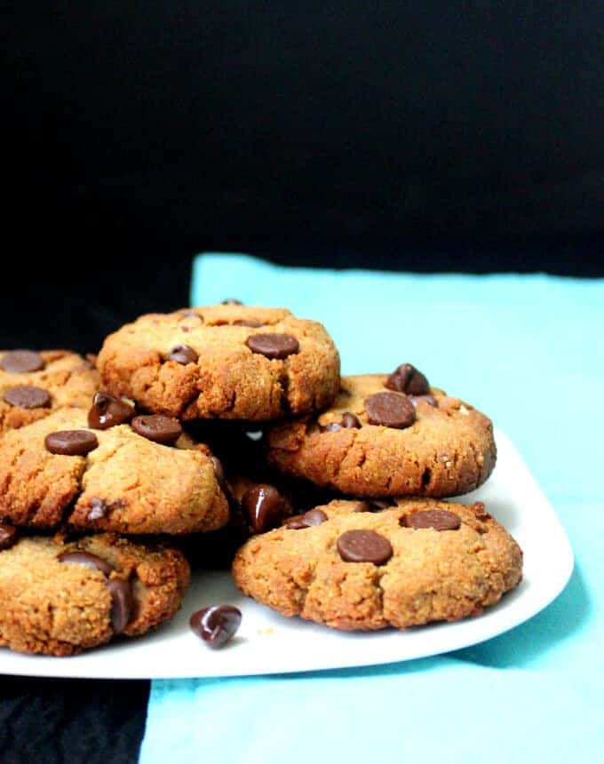 Photo of vegan gluten free chocolate chip cookies on white plate with blue napkin.