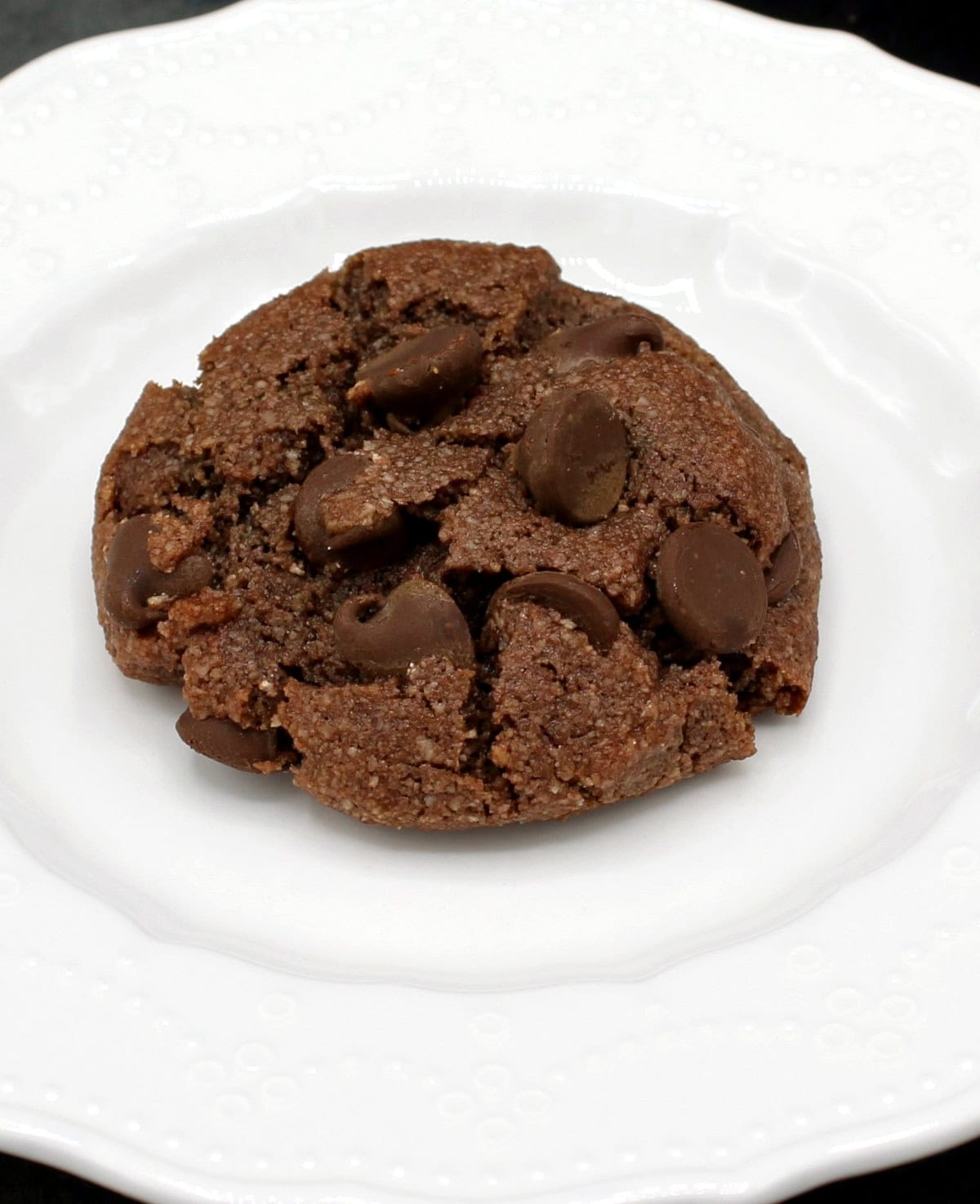 Vegan chocolate chip almond flour cookie on white plate.