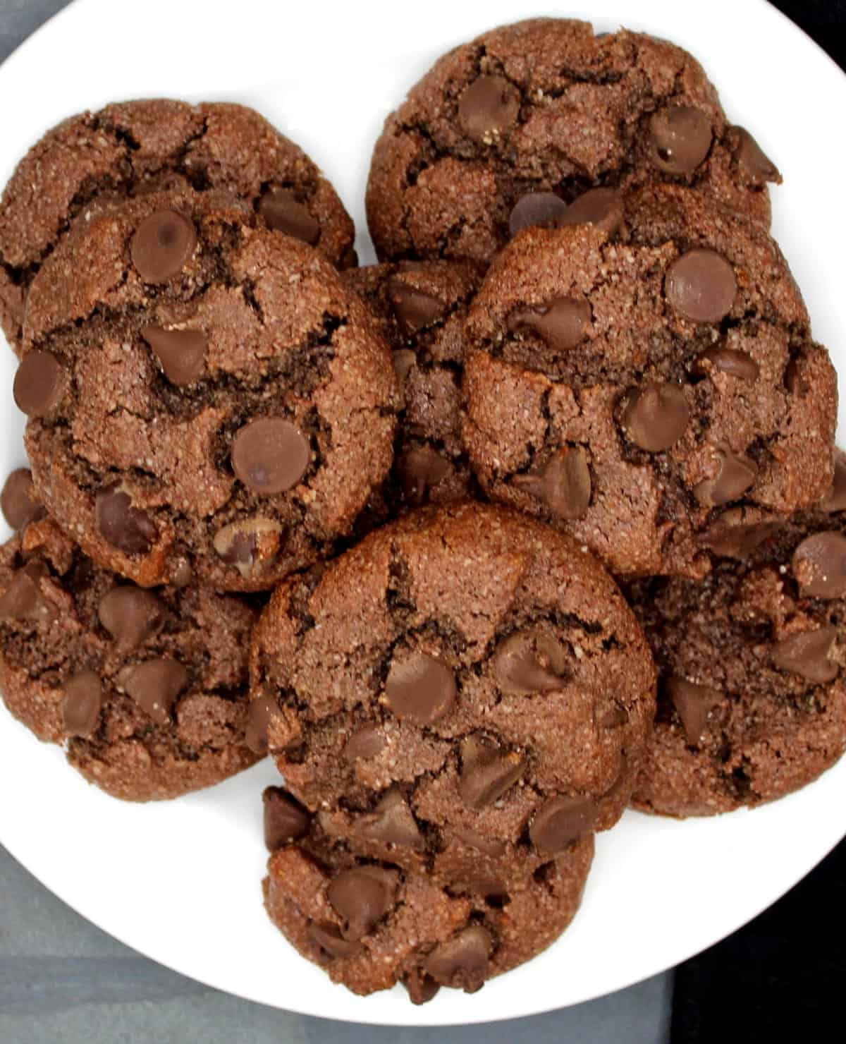 Vegan chocolate chip almond flour cookies on white plate.