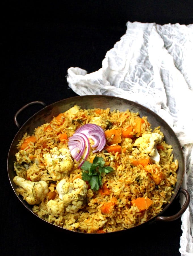 Instant Pot Butternut Squash Biryani in a copper pan with cheesecloth in the background