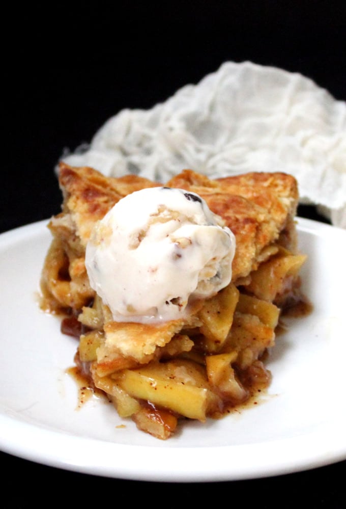 Vegan Skillet Apple Pie slice in white plate with a dollop of ice cream.