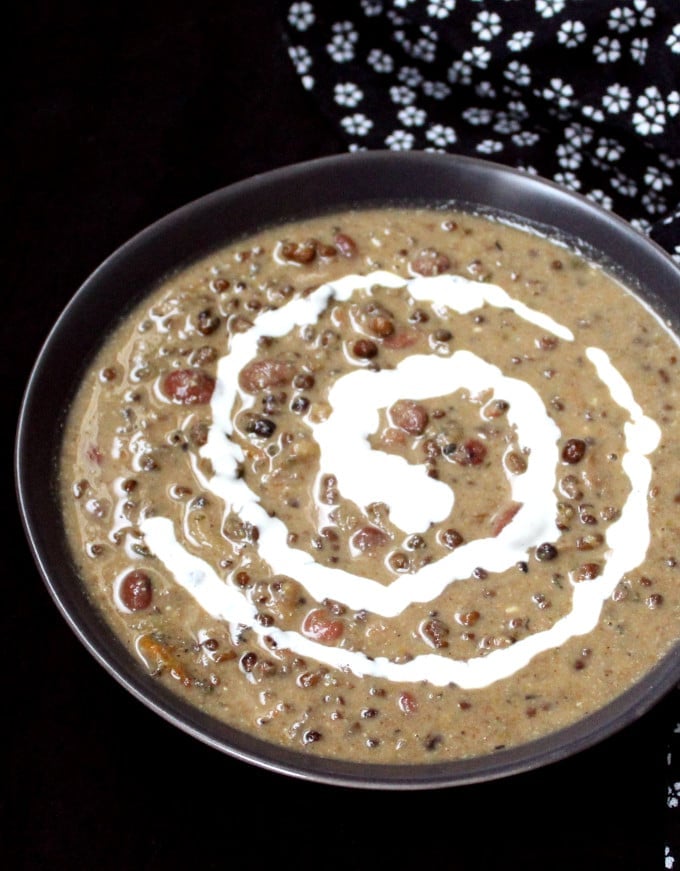 Instant Pot Vegan Dal Makhani in bowl with cashew cream swirled in.