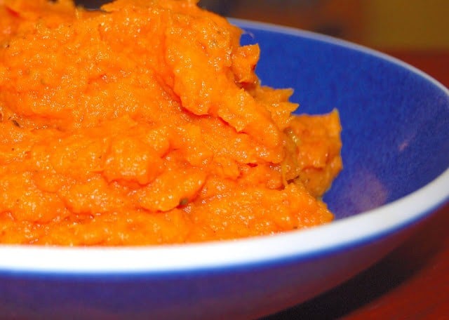 Orange sweet potatoes in blue bowl.