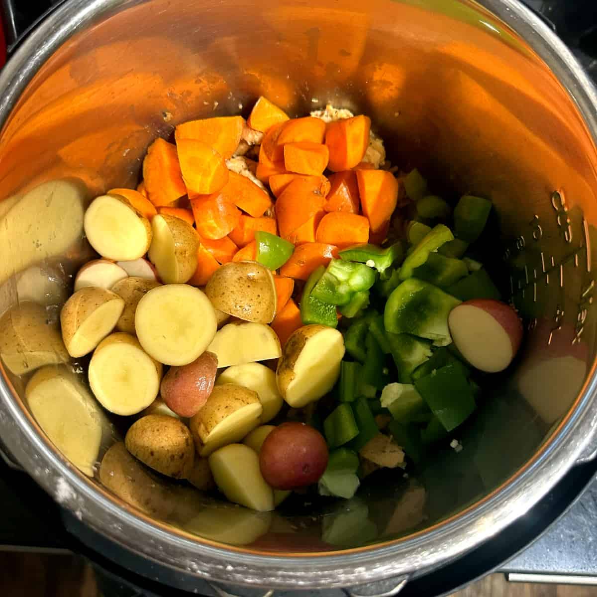 Potatoes, carrots and bell peppers in IP liner.