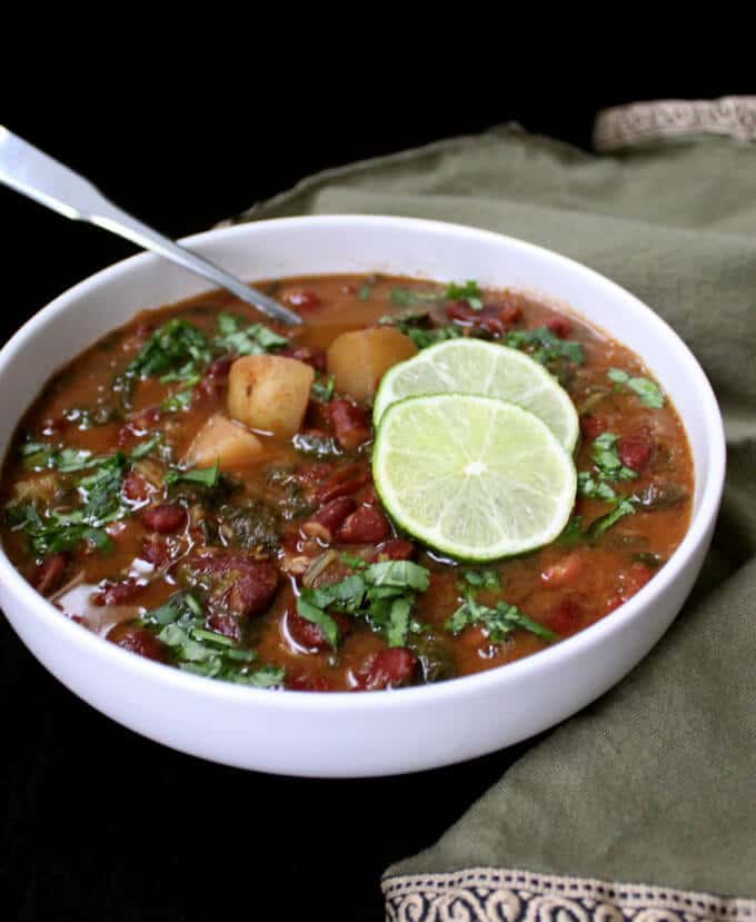 Instant Pot Kidney Beans Curry in white bowl with slices of lime.